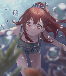 1girl absurdres ahoge air_bubble bikini blue_scrunchie blurry blurry_foreground breasts bubble cherry_print collarbone commentary coral eel fish food_print fruit_print green_tank_top hair_between_eyes hair_ornament hairclip highres holding_breath idolmaster idolmaster_shiny_colors komiya_kaho legs long_hair looking_ahead medium_breasts outstretched_arms ponytail puffy_cheeks red_bikini red_eyes scrunchie shirt short_shorts shorts sidelocks solo sparkling_eyes striped_clothes striped_shirt sunlight swimsuit swimsuit_under_clothes tank_top thighs toretate_saburou underwater white_shorts