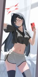 1girl absurdres black_shirt black_thighhighs blue_archive blue_eyes blush cellphone cropped_shirt grin hair_behind_ear highres holding holding_phone ichika_(blue_archive) lazhu_guang_jujiang looking_at_viewer mirror_selfie navel one_eye_closed phone shirt short_shorts short_sleeves shorts smartphone smile solo stomach taking_picture thighhighs white_shorts