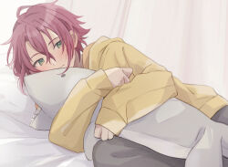 1boy animal-shaped_pillow closed_mouth ensemble_stars! green_eyes hair_between_eyes highres hugging_object isara_mao jacket long_sleeves looking_at_viewer lying male_focus on_side pillow pillow_hug red_hair reijiro short_hair sleeves_past_wrists smile solo yellow_jacket