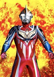 1boy 4ze_meteor alien armor arms_at_sides black_skin blue_skin breastplate clenched_hands color_timer colored_skin compound_eyes cowboy_shot dorsal_fin fiery_background fire glowing glowing_eyes highres legs_apart looking_up male_focus multicolored_skin muscular muscular_male pectorals red_skin shoulder_armor silver_skin silver_trim solo standing tokusatsu ultra_series ultraman_gaia ultraman_gaia_(series) ultraman_gaia_(super_supreme_version) white_eyes wrinkled_skin