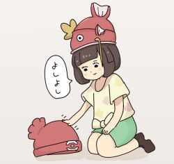 1girl 1other beanie black_eyes blush_stickers brown_hair brown_shoes fish gen_1_pokemon green_shorts hat kneeling magikarp medium_hair nintendo petting pokemon pokemon_(creature) pokemon_sm polyp23 selene_(pokemon) shirt shoes short_sleeves shorts simple_background smile speech_bubble tied_shirt translated whiskers white_background