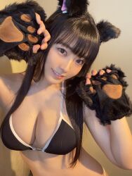 1girl animal_ears bikini black_bikini black_hair breasts brown_eyes cat_ears cat_paws cleavage gravure_idol hands_up head_tilt highres indoors japanese_(nationality) large_breasts long_hair photo_(medium) shinonome_umi standing swimsuit