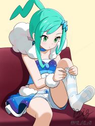 1girl adjusting_clothes adjusting_legwear blue_collar closed_mouth collar commentary_request couch earrings fur_scarf fur_trim green_eyes green_hair hair_ornament hairclip highres jewelry lisia_(pokemon) looking_down nintendo no_shoes overskirt pokemon pokemon_oras ponytail shorts sidelocks signature sitting skirt socks solo striped_clothes striped_socks vest viaigi