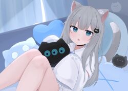 1girl :o absurdres animal_ears aqua_eyes black_choker cat_ears cat_girl cat_hair_ornament cat_tail choker commentary grey_hair hair_ornament heart heart-shaped_pillow highres indie_virtual_youtuber indoors long_hair looking_at_viewer lying nachoneko nekosakaaa on_back on_bed open_mouth pillow shirt sidelocks solo surprised tail virtual_youtuber white_shirt