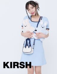 Rule 34 | 1girl, black hair, blue dress, brown eyes, dress, english text, flat chest, head tilt, indoors, japanese (nationality), kobayashi aika, looking at viewer, photo (medium), real life, short hair, smile, standing, stuffed toy, voice actor, white background
