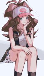 1girl absurdres asatte_3z baseball_cap black_socks black_vest blue_eyes blush brown_hair commentary_request feet_out_of_frame grin hand_on_own_chin hat head_rest highres hilda_(pokemon) long_hair looking_at_viewer nintendo notice_lines poke_ball_print pokemon pokemon_bw ponytail shirt short_shorts shorts sidelocks simple_background sitting sleeveless sleeveless_shirt smile socks solo vest white_background white_hat white_shirt