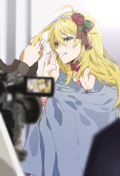 1girl 1other absurdres adjusting_another&#039;s_hair ahoge blonde_hair blurry blurry_foreground camera cloak flower green_eyes grin hair_between_eyes hair_flower hair_ornament hand_up highres hoshii_miki idolmaster idolmaster_(classic) katsu_(kana) long_hair neck_flower out_of_frame photo_shoot red_flower red_rose rose smile solo_focus