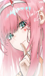 1girl artist_name blush character_name close-up closed_mouth commentary darling_in_the_franxx finger_to_mouth green_eyes hairband heart_sticker highres index_finger_raised long_hair looking_at_viewer pink_hair saka-0v0 shushing smile solo sticker_on_face white_hairband zero_two_(darling_in_the_franxx)