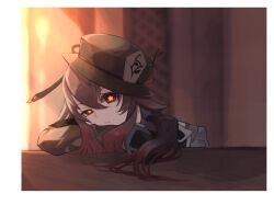 1girl arm_on_table black_hat blurry blurry_background border brown_hair elsie eyelashes genshin_impact gradient_hair hair_between_eyes hat highres hu_tao_(genshin_impact) long_hair long_sleeves looking_at_viewer multicolored_hair parted_lips red_eyes solo symbol-shaped_pupils white_border