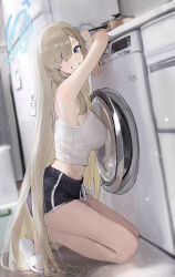 1girl absurdres armpits asuna_(blue_archive) asymmetrical_bangs bare_shoulders black_shorts blonde_hair blue_archive blue_eyes blue_halo breasts camisole grin hair_over_one_eye halo highres jianjia large_breasts long_hair looking_at_viewer midriff refrigerator short_shorts shorts sideboob slippers smile solo squatting stove very_long_hair washing_machine white_camisole