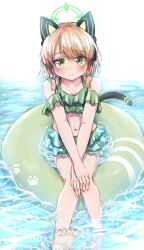 1girl absurdres alternate_costume animal_ear_headphones animal_ears bare_legs bare_shoulders barefoot bikini bikini_skirt black_tail blonde_hair blue_archive blurry blush bow breasts cat_ear_headphones cat_ears cat_tail cleavage closed_mouth collarbone commentary_request crossed_wrists depth_of_field fake_animal_ears fake_tail frilled_bikini frills green_bikini green_bow green_eyes green_halo hair_bow halo hands_on_own_knees headphones highres knees_together_feet_apart looking_at_viewer low-tied_sidelocks medium_hair midori_(blue_archive) navel off-shoulder_bikini off_shoulder own_hands_together parted_bangs sidelocks sitting smile soaking_feet solo sorap_128 splashing split_mouth swept_bangs swim_ring swimsuit tail toes water