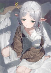 1girl bare_legs barefoot bed book commentary_request earrings ebiri_fy elf feet floating_earring frieren green_eyes jewelry long_hair mimic mimic_chest nightgown pajamas pointy_ears shirt sleepwear sleepy sousou_no_frieren squeans sweater twintails waking_up white_hair white_shirt