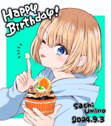 1girl 2024 aqua_background blonde_hair blue_eyes blue_hoodie character_name closed_mouth cream_on_hands cupcake food happy_birthday highres holding holding_food hood hoodie kakkou_no_iinazuke notice_lines official_art one_eye_closed outside_border short_hair solo sweets tongue tongue_out umino_sachi_(kakkou_no_iinazuke) upper_body yoshikawa_miki