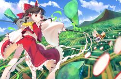 2girls ascot blue_sky bow brown_hair closed_mouth cloud commentary_request crystal danmaku day detached_sleeves fairy fairy_wings flower flying frilled_bow frilled_hair_tubes frilled_skirt frills gohei hair_bow hair_tubes hakurei_reimu highres holding holding_flower holding_gohei keiki8296 long_hair mountainous_horizon multiple_girls outdoors red_bow red_eyes red_skirt ribbon-trimmed_sleeves ribbon_trim skirt skirt_set sky smile sunflower sunflower_fairy_(touhou) touhou wings yellow_ascot yellow_flower