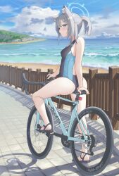 Rule 34 | 1girl, absurdres, animal ear fluff, animal ears, ass, bare arms, bare shoulders, bicycle, black one-piece swimsuit, black sandals, blue archive, blue eyes, blue halo, closed mouth, competition swimsuit, cross hair ornament, extra ears, from behind, grey hair, hair ornament, halo, highres, looking at viewer, ocean, official alternate costume, official alternate hairstyle, one-piece swimsuit, ponytail, riding, riding bicycle, sandals, sanwenyu juan bing, shiroko (blue archive), shiroko (swimsuit) (blue archive), solo, swimsuit, wolf ears, wolf girl