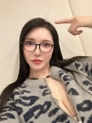 1girl animal_print asian black_hair breasts brown_eyes cleavage closed_mouth female_focus glasses highres huge_breasts indoors japanese_(nationality) jewelry leopard_print long_hair looking_at_viewer makeup necklace okita_anri photo_(medium) real_life red_lips solo