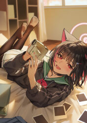 1girl absurdres animal_ears bed_sheet black_choker black_hair black_jacket blue_archive blush brown_pantyhose cat_ears choker colored_inner_hair commentary extra_ears feet feet_up green_sailor_collar halo highres indoors jacket kazusa_(blue_archive) looking_at_viewer lying multicolored_hair pantyhose photo_(object) pink_hair qianyuu_(senba) red_eyes sailor_collar school_uniform short_hair smile soles solo two-tone_hair