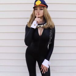 Rule 34 | 1girl, black bodysuit, blonde hair, bodysuit, boku no hero academia, breasts, cleavage, cosplay, cosplay photo, crypticjinx, female focus, finger to mouth, hat, highres, instagram username, large breasts, long hair, looking at viewer, mole, mole on breast, peaked cap, photo (medium), real life, skin tight, solo, utsushimi kemii, utsushimi kemii (cosplay), wrist cuffs