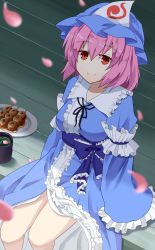 1girl arm_garter blue_hat blue_kimono blurry blurry_foreground breasts commentary_request cropped_legs cup dango feet_out_of_frame food furisode hair_between_eyes hat highres japanese_clothes kimono large_breasts long_sleeves looking_at_viewer mob_cap obi petals petals_on_liquid pink_hair plate red_eyes saigyouji_yuyuko sash short_hair sitting sleeves_past_fingers sleeves_past_wrists smile solo sugiyama_ichirou touhou triangular_headpiece veranda wagashi yunomi