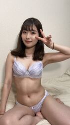 1girl bra breasts e_(nationality) long_hair navel on_bed photo_(medium) real_life smile underwear v