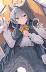 1girl 1other absurdres ahoge animal_ear_headwear animal_ear_hood animal_ears black_capelet black_hood black_skirt book bow bowtie capelet commentary_request fake_animal_ears fox_ears fox_girl gloves green_eyes hair_ornament hairclip hands_on_another&#039;s_hand heterochromia highres hood long_hair long_sleeves looking_at_viewer lying on_floor original pleated_skirt shirt skirt white_gloves white_shirt wlswlp wooden_floor yellow_bow yellow_bowtie yellow_eyes