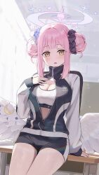 1girl absurdres arm_support black_jacket black_shorts blue_archive blurry blush bokeh breasts center_opening classroom cleavage commentary_request depth_of_field desk double_bun feathered_wings gym_shorts hair_bun hair_ornament hair_scrunchie halo highres indoors jacket large_breasts long_sleeves looking_at_viewer low_wings mika_(blue_archive) mika_(track)_(blue_archive) multicolored_jacket official_alternate_costume official_alternate_hairstyle on_desk open_mouth pink_hair pink_halo school_desk scrunchie short_shorts shorts sitting solo sports_bra tem_(tempainting1) thighs trinity_general_school_logo turtleneck turtleneck_jacket two-tone_jacket white_jacket white_sports_bra white_wings wing_ornament wings yellow_eyes