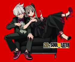 1boy 1girl anniversary betti_(xx_betti) black_dress black_pants black_scrunchie black_shoes black_suit bow bowtie brown_hair closed_mouth collared_shirt copyright_name couch cup dress drinking_glass formal_clothes green_eyes green_vest grey_hair grin hair_ornament hair_scrunchie hand_on_own_knee high_heels highres holding holding_cup jacket locked_arms looking_at_another looking_at_viewer maka_albarn medium_hair on_couch pants reclining red_background red_bow red_bowtie red_eyes scrunchie sharp_teeth shirt shoes short_hair simple_background sitting smile sneakers soul_eater soul_evans strapless strapless_dress strappy_heels suit suit_jacket teeth twintails vest white_shirt wine_glass