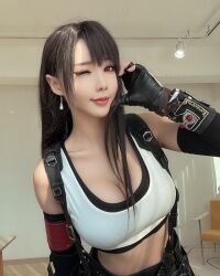 1girl bare_shoulders black_gloves black_hair black_skirt breasts cosplay cosplay_photo female_focus final_fantasy final_fantasy_vii final_fantasy_vii_remake fingerless_gloves gauntlets gloves highres indoors ja10888 large_breasts long_hair looking_at_viewer one_eye_closed photo_(medium) real_life skirt solo tank_top tifa_lockhart tifa_lockhart_(cosplay) white_tank_top
