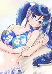 1girl absurdres beach bikini blue_bikini blue_eyes blue_hair blush breasts cleavage collarbone day floral_print hair_ribbon highres isuzu_(kancolle) isuzu_kai_ni_(kancolle) isuzu_kai_ni_(swimsuit)_(kancolle) kantai_collection large_breasts long_hair looking_at_viewer lying navel neko_to_imo outdoors ribbon sand sarong single-shoulder_bikini smile solo swimsuit twintails