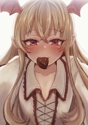 1girl blonde_hair blurry blush candy chocolate chocolate_heart collarbone commentary_request female_focus food granblue_fantasy head_wings heart highres long_hair looking_at_viewer mouth_hold pointy_ears red_eyes shingeki_no_bahamut smile solo upper_body usameruti vampy wings