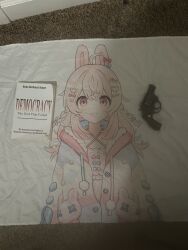 blanket book carpet gun handgun hans-hermann_hoppe highres hood hoodie indie_virtual_youtuber jacket open_clothes open_jacket pajamas phase_connect photo_(medium) pink_eyes pink_hair pipkin_pippa revolver weapon
