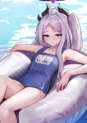 1girl absurdres ahoge black_halo blue_archive blush breasts day demon_girl demon_horns halo highres hina_(blue_archive) hina_(swimsuit)_(blue_archive) horns innertube long_hair looking_at_viewer lying nonoka7221 ocean old_school_swimsuit outdoors purple_eyes school_swimsuit small_breasts solo swim_ring swimsuit white_hair