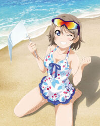 1girl artbook barefoot beach blue_eyes blush breasts casual_one-piece_swimsuit cleavage day eyewear_on_head flag grey_hair grin highres holding holding_flag looking_at_viewer love_live! love_live!_sunshine!! medium_breasts non-web_source ocean official_art one-piece_swimsuit one_eye_closed outdoors sand short_hair sitting smile solo sunglasses swimsuit wariza watanabe_you water