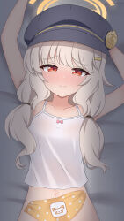 1girl absurdres aoba_(blue_archive) arms_up bare_shoulders bed_sheet black_hat blue_archive blush camisole closed_mouth commentary english_commentary furrowed_brow hair_over_shoulder halo hat highres lock_003 long_hair looking_at_viewer lying navel on_back on_bed orange_halo orange_panties panties polka_dot polka_dot_panties red_eyes solo underwear unworn_panties upper_body white_camisole white_hair